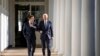 U.S. President Joe Biden and French President Emmanuel Macron walk down the Colonnade to the Oval Office at the White House, Dec. 1, 2022.