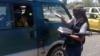FILE - A fighter with the Islamic State distributes a copy of the Quran, Islam's holy book, to a driver in Mosul, Iraq, June 22, 2014. Islamic scholars in Bangladesh are denouncing activities of the Islamic State.