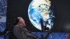 FILE - Physicist Stephen Hawking sits on stage during an announcement of the Starshot initiative with investor Yuri Milner in New York, April 12, 2016. A partnership was announced this week with the European Southern Observatory, which will use one of their telescopes to hunt for inhabitable planets. 