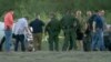 In this frame grab taken from video provided by KRGV, authorities gather near where a helicopter flying over the U.S.-Mexico border in Texas crashed, killing two National Guard soldiers and a U.S. Border Patrol agent on March 8, 2024. (KRGV via AP)