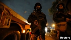 Riot police secure the scene of a bus blast in Giza, Egypt, Dec. 28, 2018.