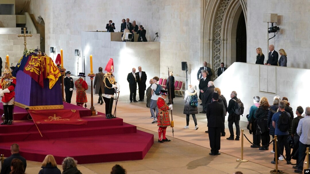 US President Joe Biden and First Lady Jill Biden, far right, view the coffin of Queen Elizabeth II lying in state on the catafalque in Westminster Hall, at the Palace of Westminster, London, Sept. 18, 2022.
