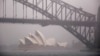 FILE - A boat passes under the Sydney Harbour Bridge and in front of the Sydney Opera House as strong winds and heavy rain hit the city of Sydney, Australia, Nov. 28, 2018. 