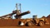 FILE - Earth moving equipment work at the site of Fortescue Metals Group's Christmas Creek iron ore operations in the Pilbara region of Western Australia, June 17, 2014.