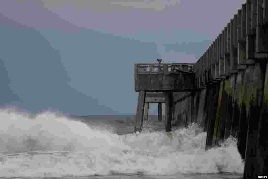 Waves crash along a pier as Hurricane Michael approaches Panama City Beach, Florida, Oct. 9, 2018.