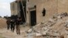 Free Syrian Army fighters run with their weapons during clashes with forces loyal to Syria's President Bashar al-Assad at the Karam Barre front line in Aleppo, Nov. 2, 2014. 