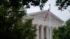 FILE - An American flag waves in front of the U.S. Supreme Court building, June 27, 2022, in Washington.