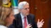 Deputy Attorney General Lisa Monaco, left, looks on as Attorney General Merrick Garland delivers a statement following a briefing on a fugitive apprehension initiative at the Department of Justice in Washington, July 6, 2022.