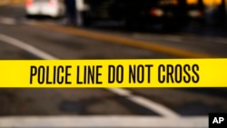FILE - Police tape is seen at the scene of a 2021 shooting.