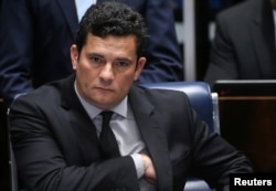 FILE - Brazilian federal judge Sergio Moro reacts during a session at the Federal Senate in Brasilia, Brazil, Dec. 1, 2016.