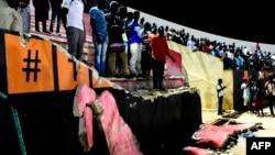 Des spectateurs devant un mur effondré au stade Demba Diop, à Dakar, le 15 juillet 2017.