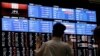 Media members observe the stock quotation board at the Tokyo Stock Exchange in Tokyo, Japan, Aug. 6, 2024.