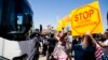 FILE - Demonstrators rally against the arrival of undocumented migrants who were scheduled to be processed at the Murrieta Border Patrol Station in Murrieta, California, July 1, 2014.