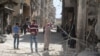 Warga setempat memeriksa kerusakan pasca serangan udara di wilayah al-Maysar, Aleppo, Suriah (11/4). 