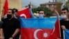 Demonstrators holding Azeri and Turkish flags shout slogans during a protest against Armenia near the Consulate of Azerbaijan in Istanbul, Turkey, Sept. 29, 2020.