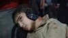 An injured boy waits for treatment in a field hospital after what activists said was an airstrike by forces loyal to Syria's President Bashar al-Assad in the Duma neighborhood of Damascus, Dec. 23, 2014. 