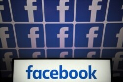 FILE - A photo taken July 4, 2019, in Nantes, France, shows logos of the U.S.-based social media platform Facebook.