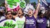 Para perempuan pendukung hak-hak aborsi merayakan keputusan Mahkamah Agung AS, di Washington, Senin (27/6).