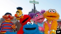 FILE - Characters from "Sesame Street Live" appear on the street by Madison Square Garden to celebrate the 30th anniversary of the live touring stage shows based on the PBS television series in New York, Feb. 4, 2010. The nonprofit behind TV's "Sesame Street" is using the Muppets to entertain and instruct kids who've known nothing but war in the Mideast.