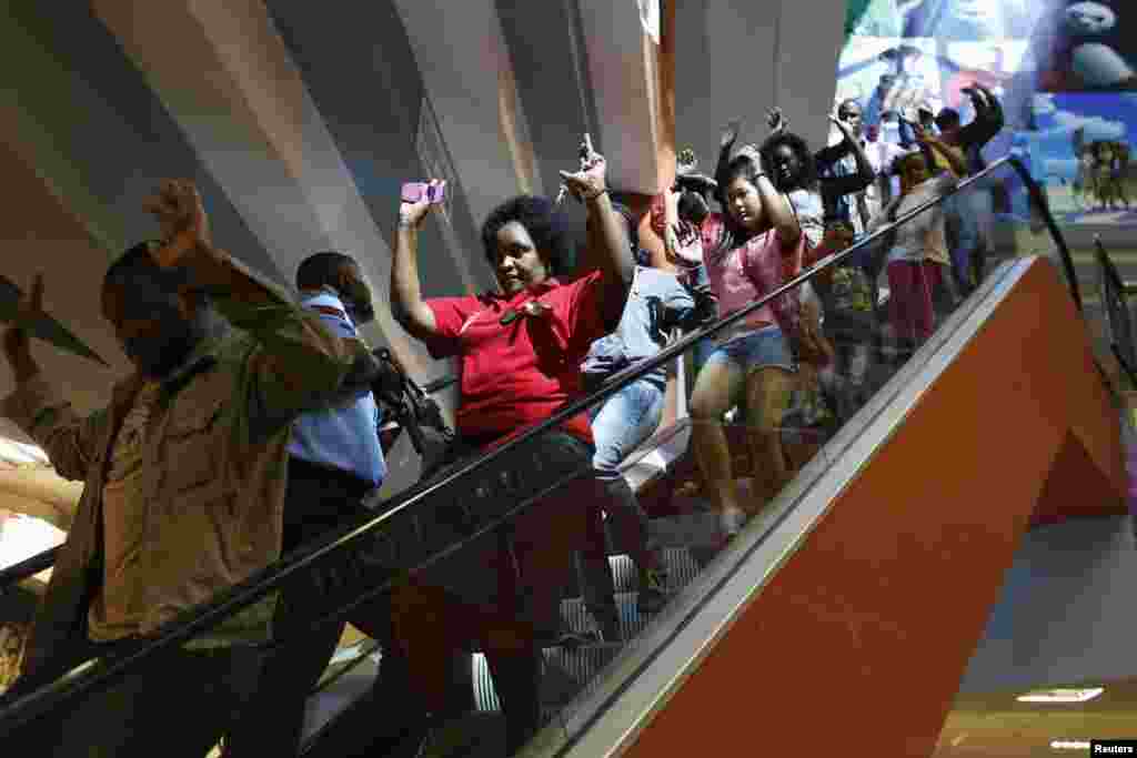 Para pengunjung berbaris menuruni tangga berjalan untuk keluar dari mal Westgate di Nairobi, menyusul serangan teroris yang menewaskan lebih dari 70 orang (21/9).&nbsp; 