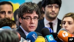 FILE - Fugitive Catalan leader Carles Puigdemont addresses reporters in Brussels, Belgium, Jan. 24, 2018.