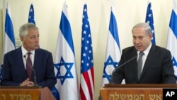 U.S. Secretary of Defense Chuck Hagel, left, listens at a joint press conference with Israeli Prime Minister Benjamin Netanyahu at the latter's office in Jerusalem, April 23, 2013.