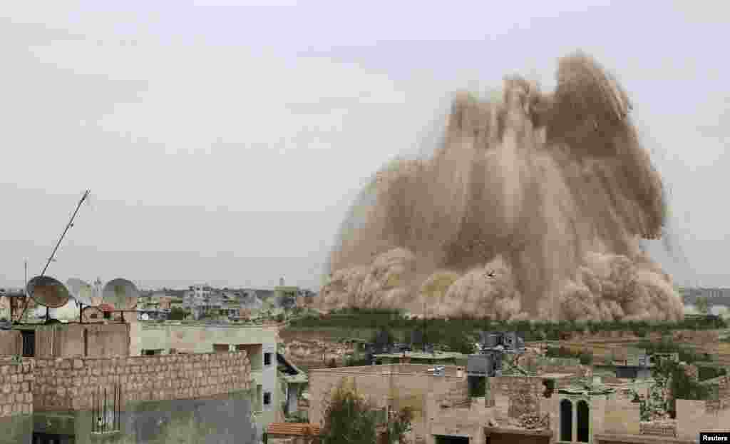 Asap mengepul di distrik Al-Sahaba di Maarat Al-Nouman, provinsi Idlib akibat bentrokan antara pasukan Suriah dan pemberontak.