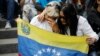 Opposition supporters hold a Venezuelan flag during a prayer event with opposition leader Maria Corina Machado and presidential candidate Edmundo Gonzalez in Caracas, Venezuela, July 21, 2024. Venezuela is set to hold presidential elections July 28. 