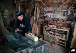 Nicolae Dascalu, 58, owner of a small carpentry company, works in Dambu, Romania, Dec. 8, 2016.