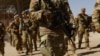 National Guard soldiers walk on the day U.S. authorities hold a ceremony to deputize the Texas National Guard to enforce Title 8 immigration laws, near the U.S.-Mexico border in El Paso, Texas, Feb. 27, 2025.