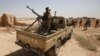 FILE - Iraqi troops monitor an area west of the shrine city of Karbala, in central Iraq, June 29, 2014. 