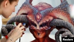 An artist airbrushes a model during the "World Bodypainting Festival 2017" in Klagenfurt, Austria, July 28, 2017.