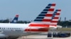 FILE - American Airlines planes wait on the tarmac at Washington's Reagan National Airport.