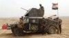 Military reinforcements for Iraqi anti-terrorism forces arrive at the Ramadi Stadium after regaining control of the complex and the neighboring al-Bugleeb area, Oct. 6, 2015.