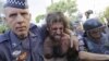 A protester is detained by police during a demonstration demanding better public services and protesting the money spent on the World Cup soccer tournament in Sao Paulo, Brazil, June 12, 2014.