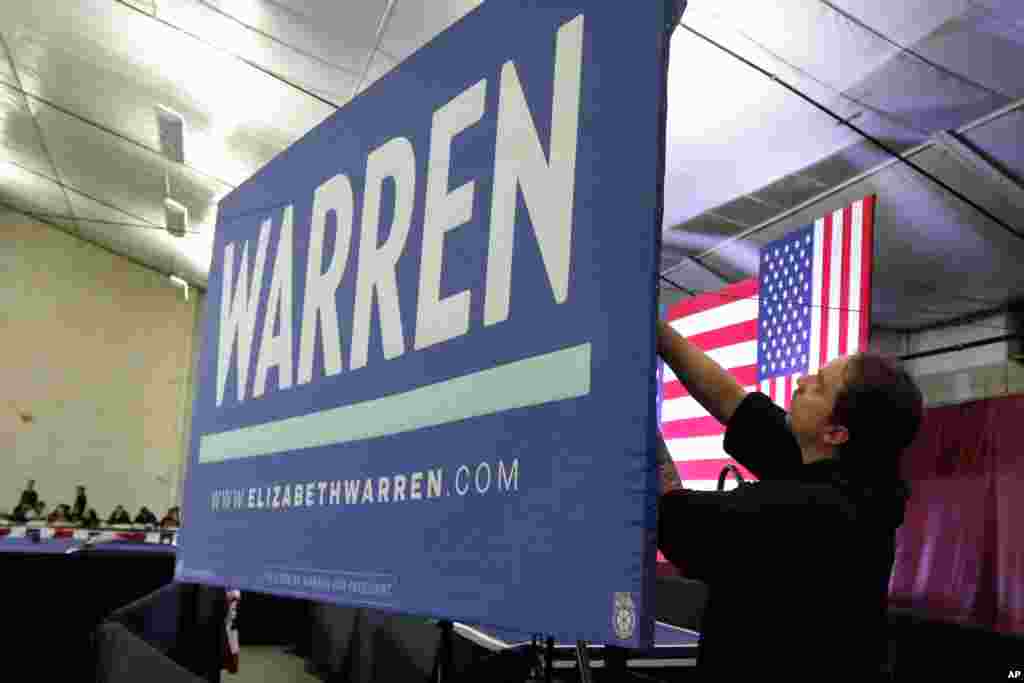 A worker preparess the stage for a primary election night rally for Democratic presidential candidate Sen. Elizabeth Warren, Feb. 11, 2020, in Nashua, N.H.