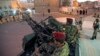 Houthi fighters in army uniforms patrol outside the presidential palace in Sana'a, Yemen, Feb. 6, 2015.