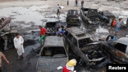 Residents gather at the site of bomb attacks in Baghdad, Iraq, May 27, 2013. 