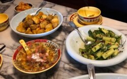 Some of the popular dishes at the Pepper Twins restaurant, clockwise from the upper left: Golden Eggplant (top), Spicy Persian Cucumber (right), Crystal Pudding (left).
