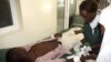 Nurses attend to a victim of the clashes between the pastoralists and farmers within the Tana Delta region, at the Malindi District hospital in Tana River, Kenya, September 7, 2012. 