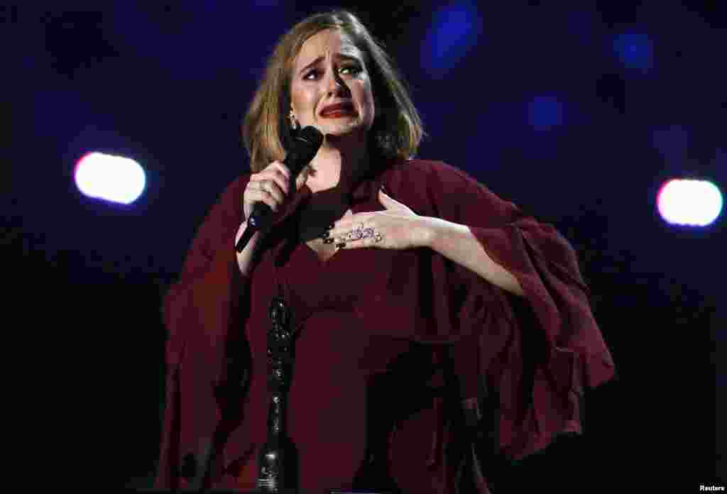 Adele reacts as she accepts the global success award at the BRIT Awards at the O2 arena in London, Feb. 24, 2016. 