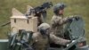 FILE - U.S. soldiers sit in a tank during a military exercise in Grafenwoehr, Germany, May 12, 2017.