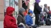 FILE - Practitioners of Falun Dafa, also called Falun Gong, meditate and exercise outside of the Chinese consulate, Thursday, April 25, 2019, in New York. Ping Li, 59, provided information to China about an individual affiliated with the Falun Gong movement.