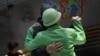 FILE - Patients with Alzheimer's and dementia dance inside the Alzheimer's Foundation in Mexico City, April 19, 2012.
