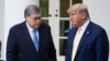 FILE - U.S. President Donald Trump turns over the podium to U.S. Attorney General William Barr to address the coronavirus daily briefing at the White House in Washington, March 23, 2020. 