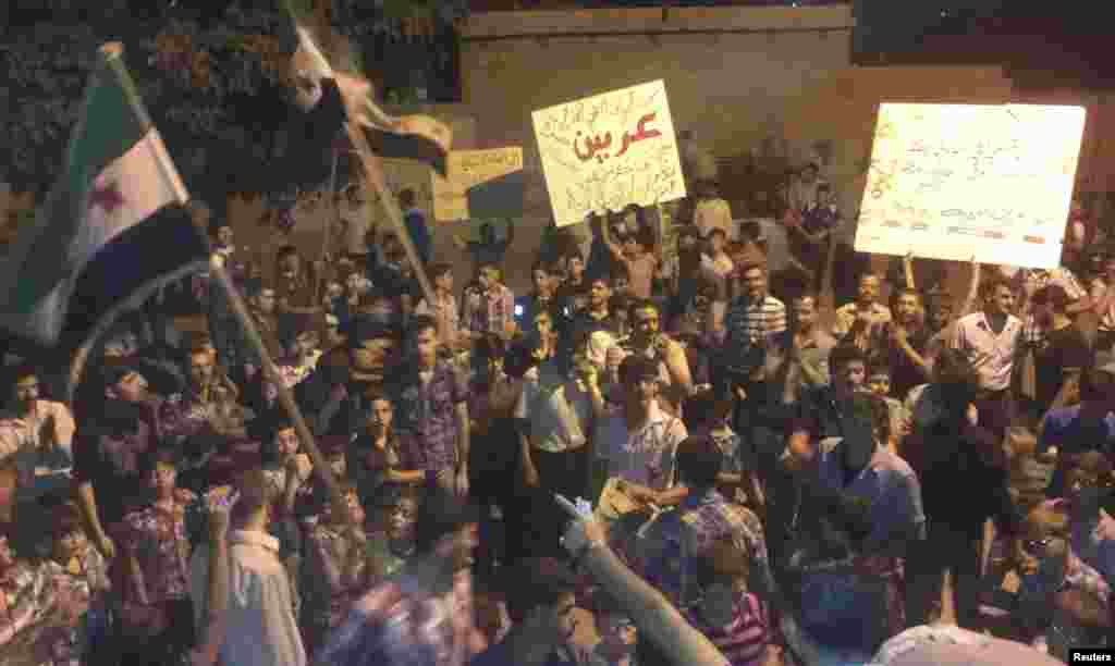 Demonstrators protest against Syria's President Bashar al-Assad in Erbeen, near Damascus, September 16, 2012.