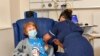  Margaret Keenan, 90, is the first patient in the UK to receive the Pfizer-BioNTech COVID-19 vaccine, at University Hospital, Coventry, England, Dec. 8, 2020.