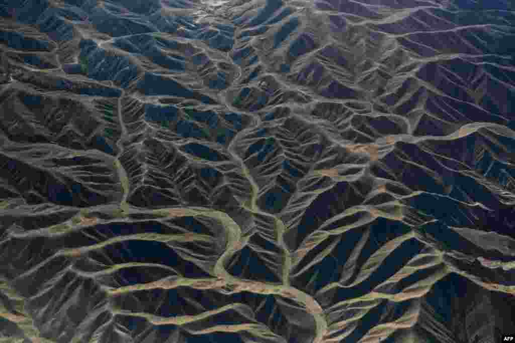 In this aerial photograph, dry river beds snake among the rugged terrain in eastern Afghanistan.