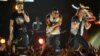 Nelly, center, and Brian Kelley, left, and Tyler Hubbard, of musical group Florida Georgia Line, perform at ACM Presents: Tim McGraw's Superstar Summer Night at the MGM Grand Garden Arena, April 8, 2013, in Las Vegas.