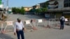 Policemen stand guard along a barricaded street near an army cantonment, a day after it was attacked by a militant suicide squad in Bannu, northwestern Pakistan, July 16, 2024.